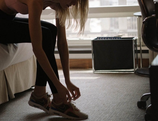 a woman tying her shoes