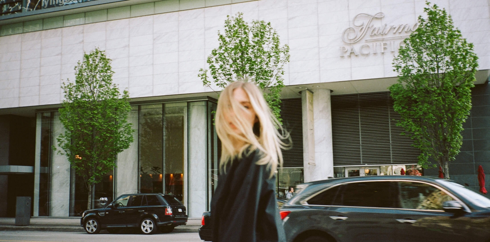 A girl standing in front of a luxury hotel in Vancouver