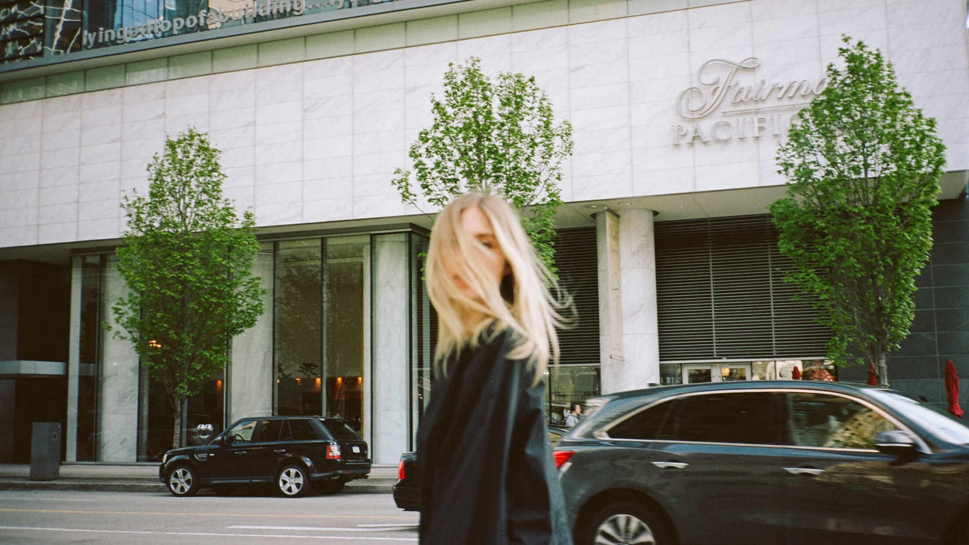 A girl standing in front of a luxury hotel in Vancouver