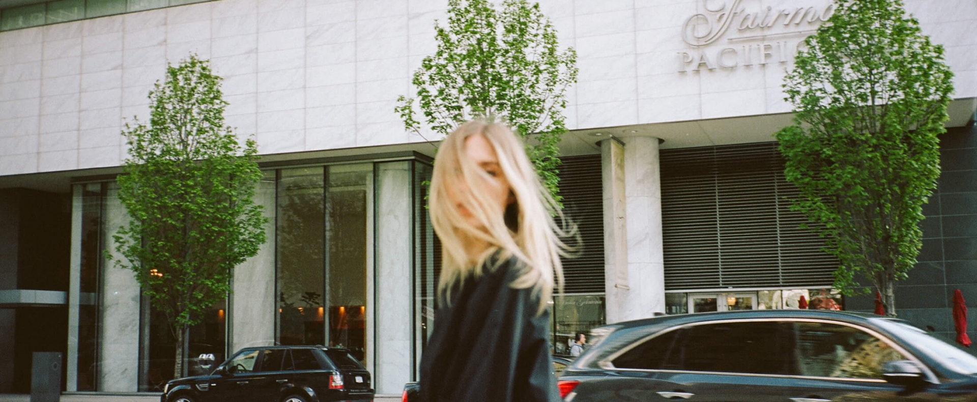 A girl standing in front of a luxury hotel in Vancouver