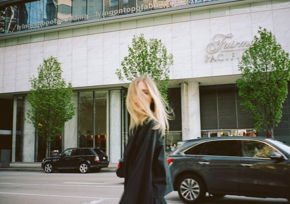 A girl standing in front of a luxury hotel in Vancouver