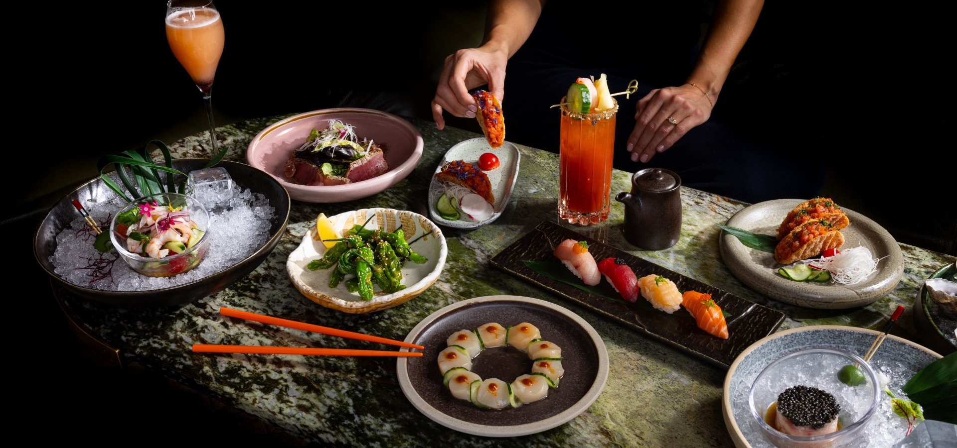 A table of Asian shareable dishes and sushi on downtown Vancouver