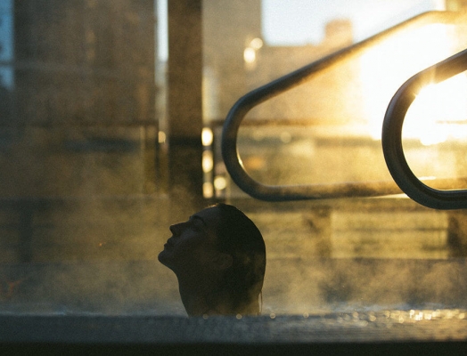Woman in hot tub on rainy day