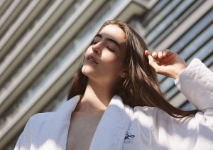 A women in a Fairmont Hotel robe in the sunlight