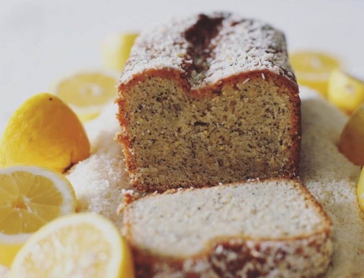 A lemon loaf with halved lemons
