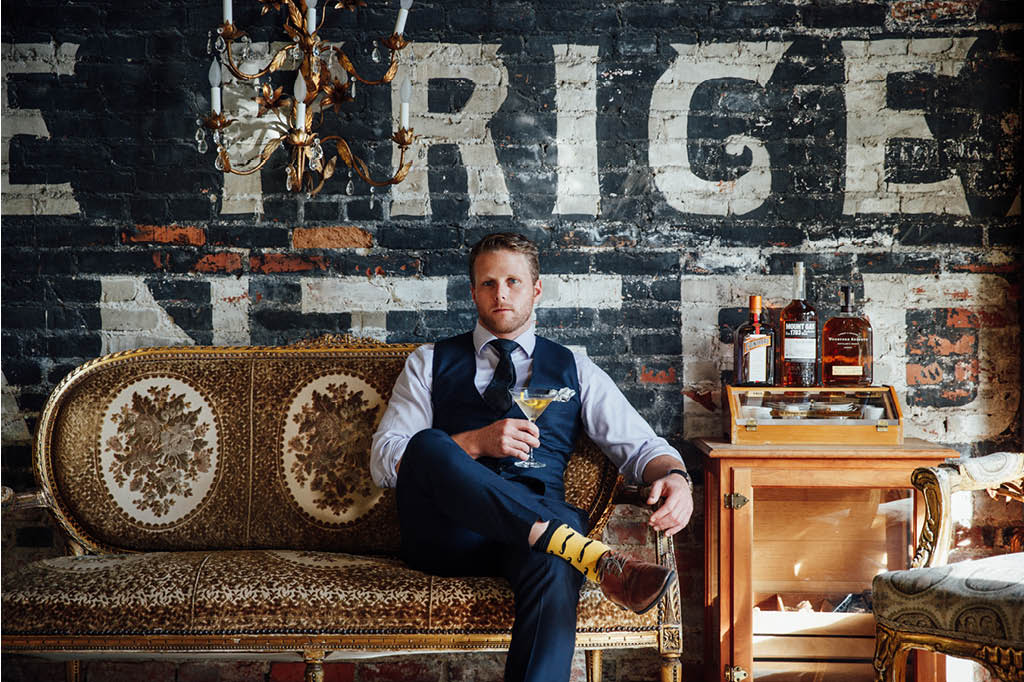 well dressed man holding a drink