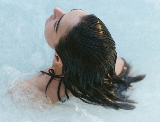 Woman in hottub leaning back in water