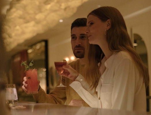 A couple enjoying cocktails at a bar