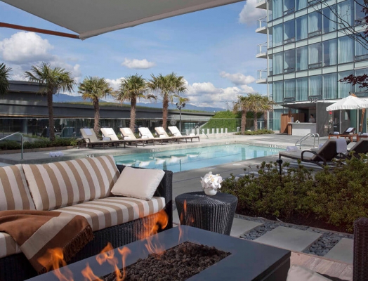 A sunny pool with patio furniture