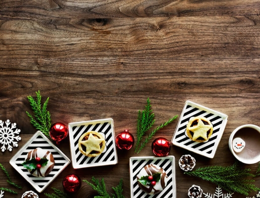 Christmas ornaments and baked goods on a wooden table