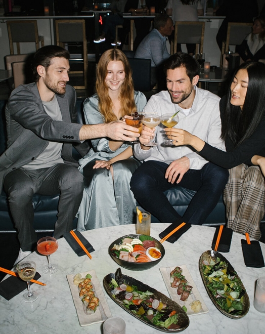 Group of people clinking their drinks