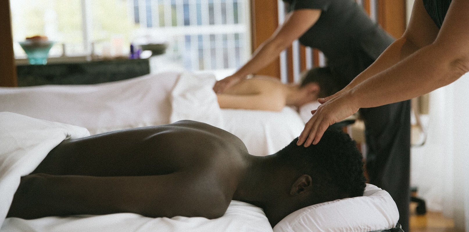 Two people getting massages at the spa in Fairmont Pacific Rim