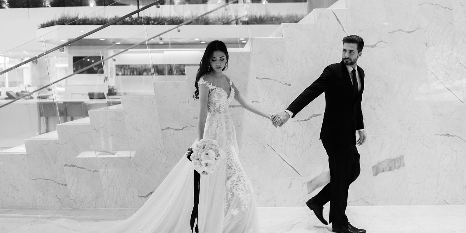 bride and groom holding hands at a hotel wedding venue in Vancouver