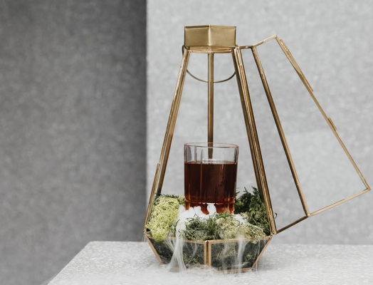 beverage in terrarium with liquid nitrogen pouring out