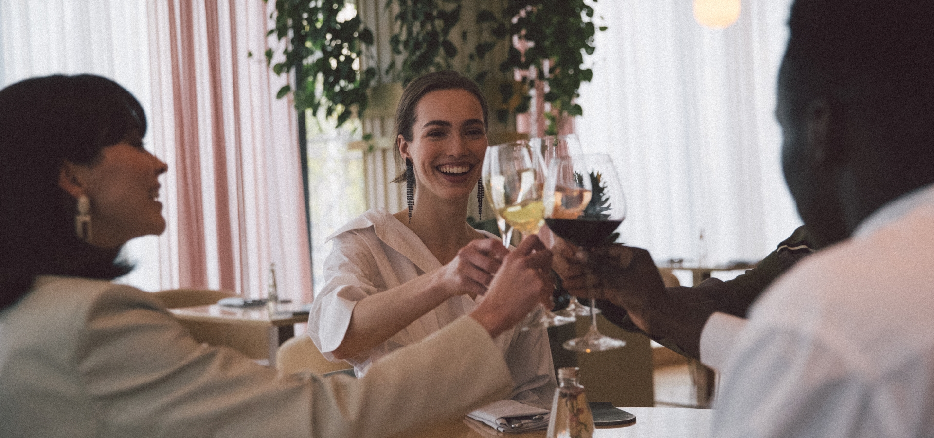 Group of people having enjoying wine at Botanist restaurant