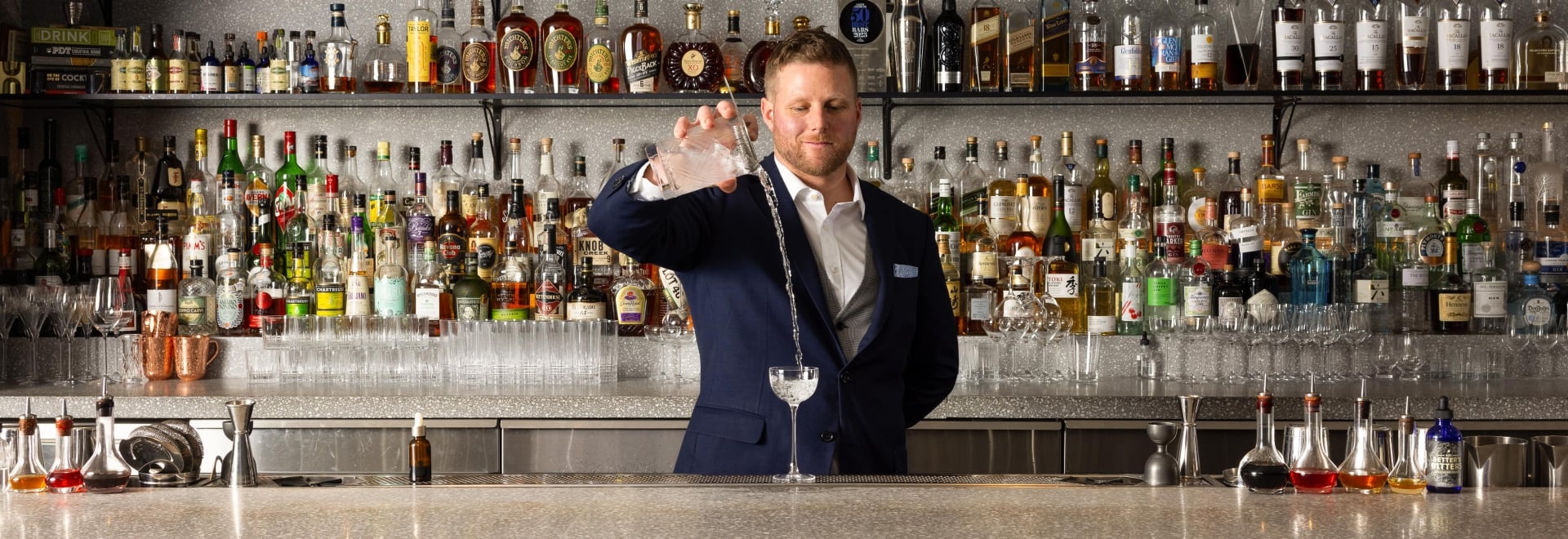 Grant Sceney pouring a drink at Botanist Bar in downtown Vancouver