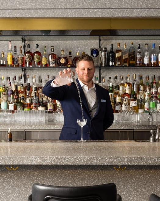 Grant Sceney pouring a drink at Botanist Bar in downtown Vancouver