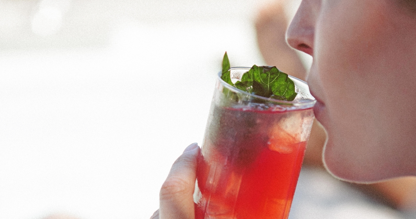 Woman enjoying a summer cocktail in a rooftop pool in a luxury hotel in Vancouver