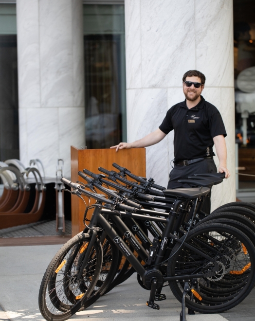 A bike butler at Fairmont Pacific Rim showing the e-bikes at the hotel in Vancouver
