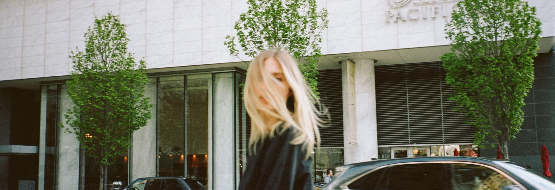 Woman in front of luxury hotel in downtown Vancouver
