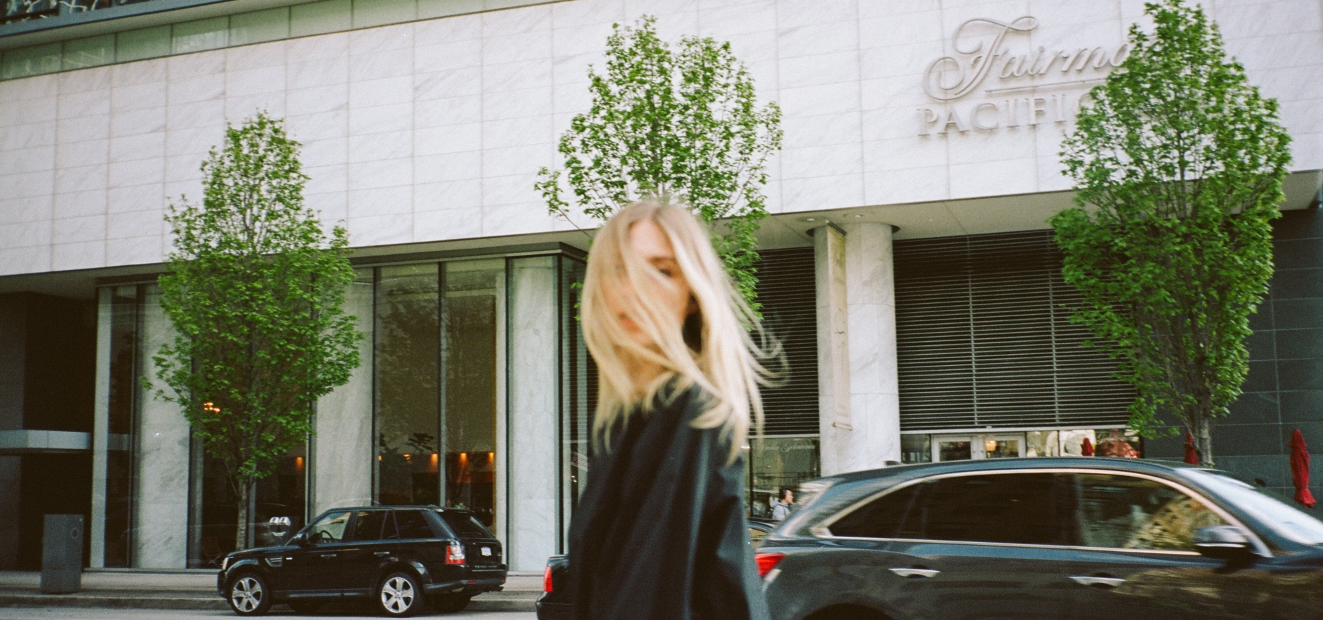 Woman in front of luxury hotel in downtown Vancouver