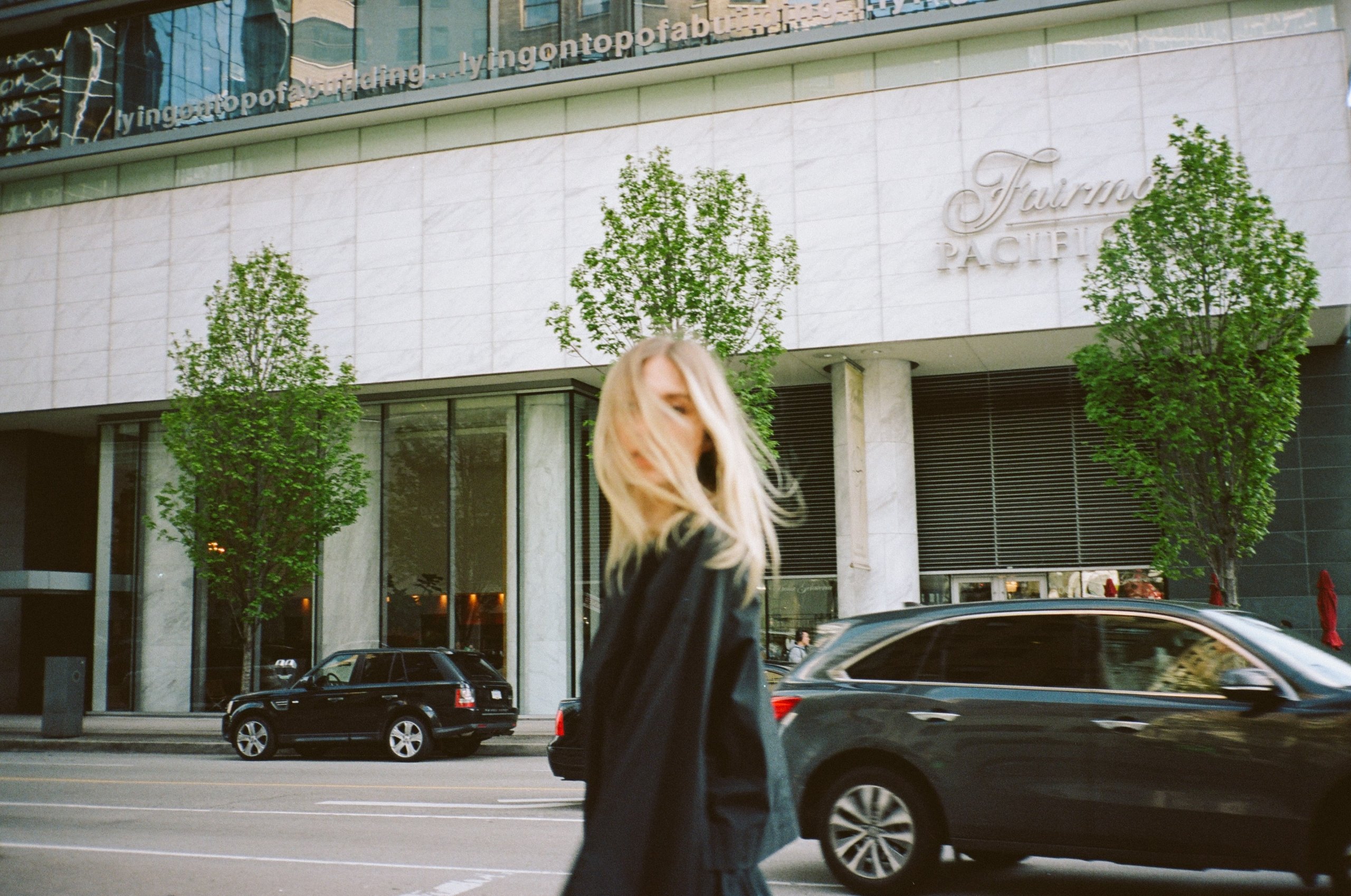 Woman in front of luxury hotel in downtown Vancouver