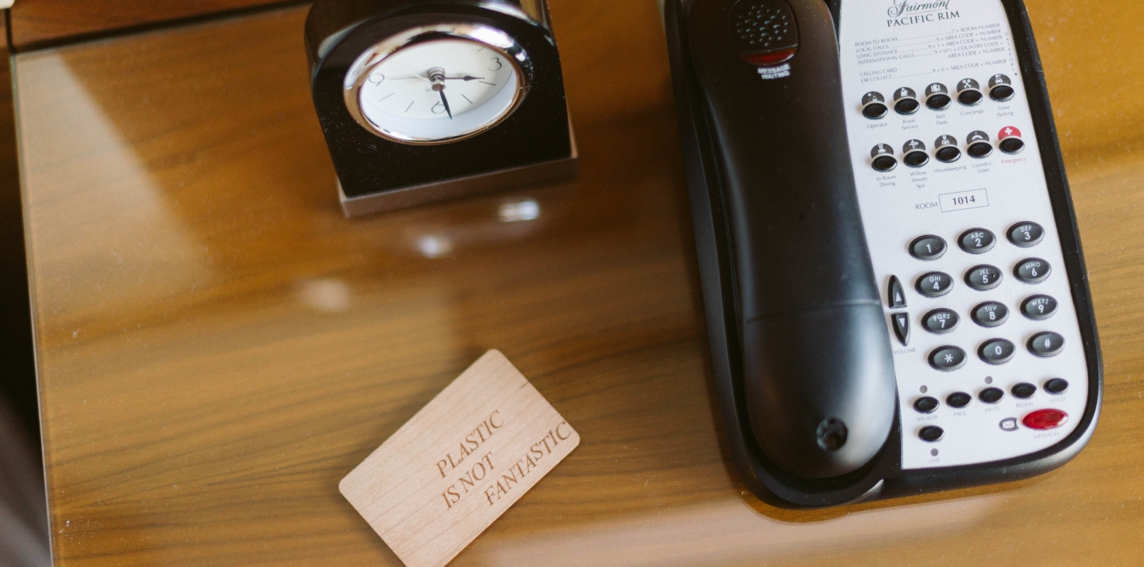 Sustainable key card beside hotel telephone