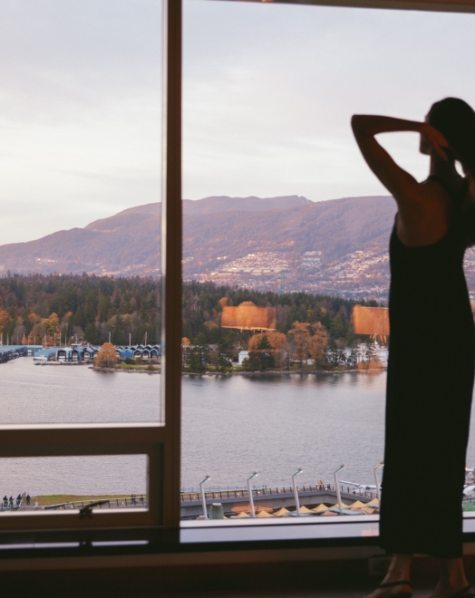 Woman overlooking great views in a luxury hotel in Vancouver