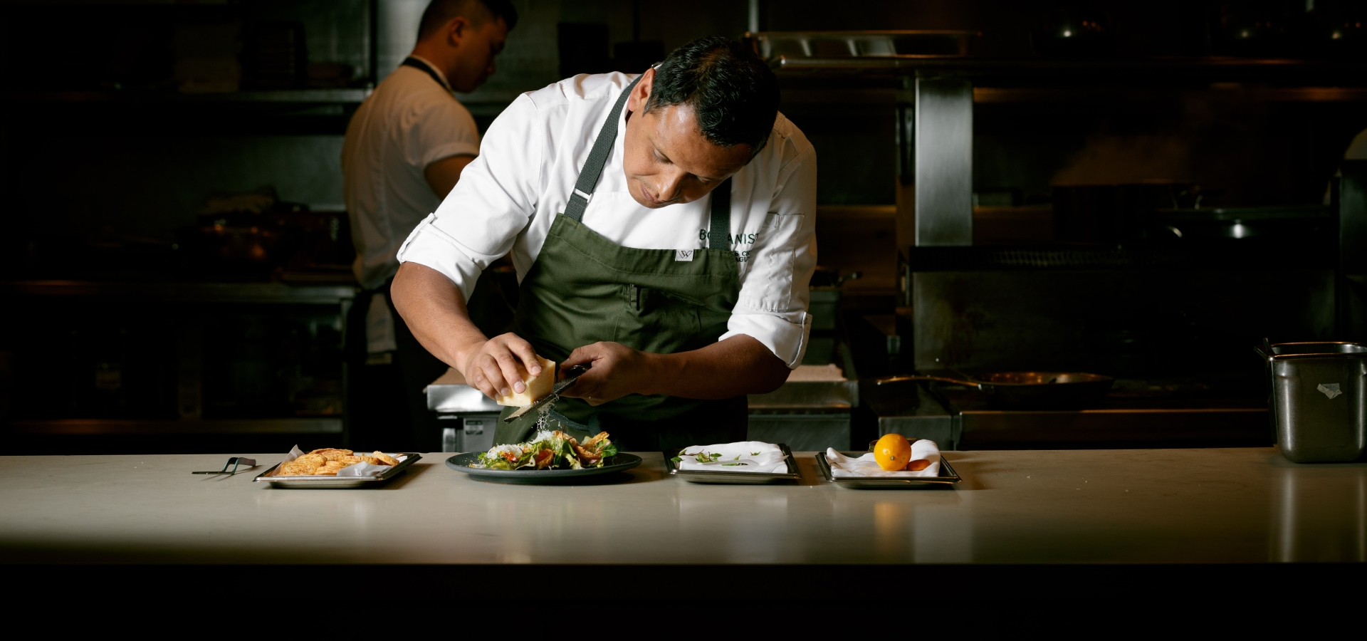 Chef Hector Laguna plating a dish at Botanist