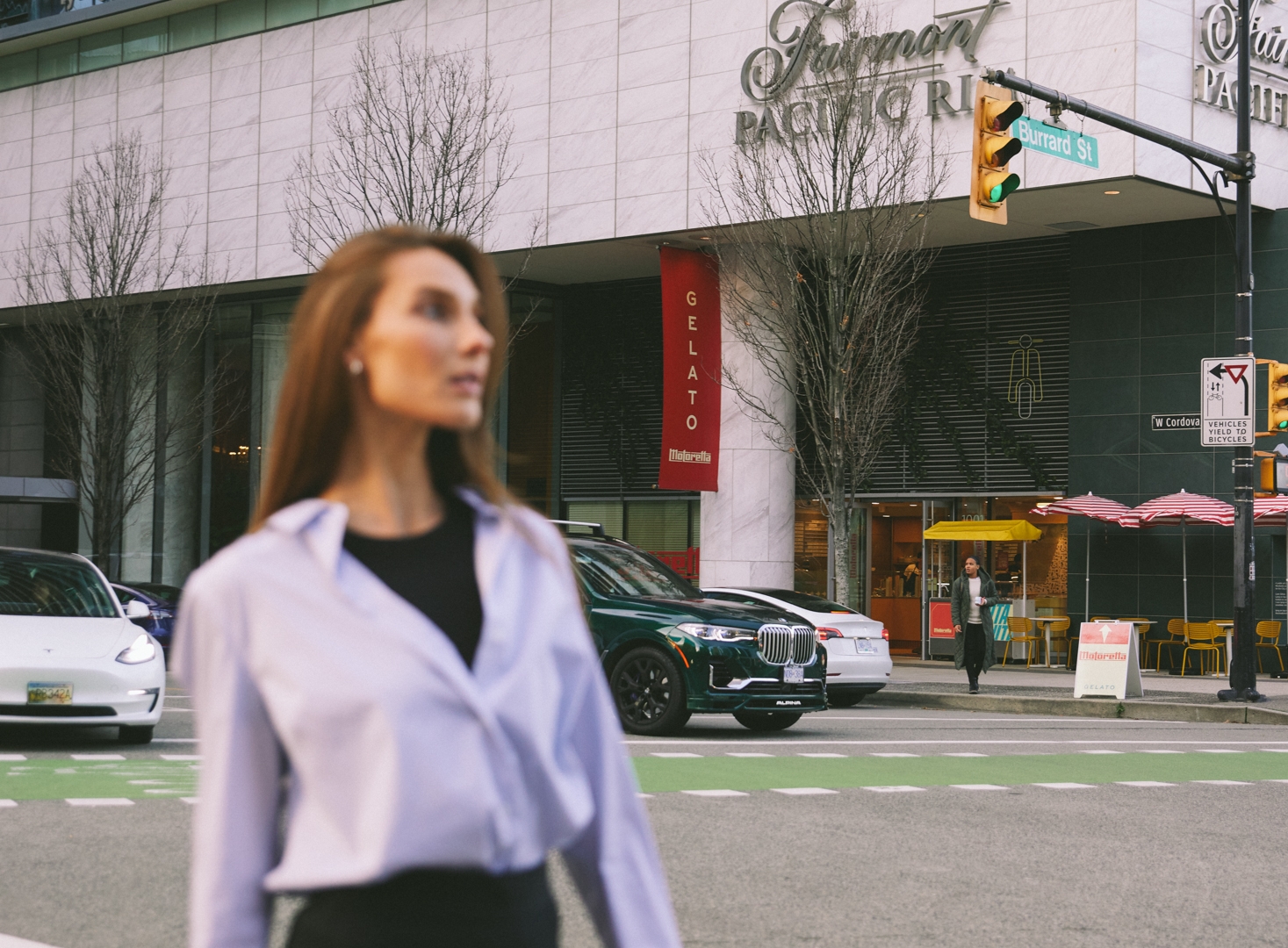 Woman outside Fairmont Pacific Rim looking for Labour Day weekend activities in Vancouver