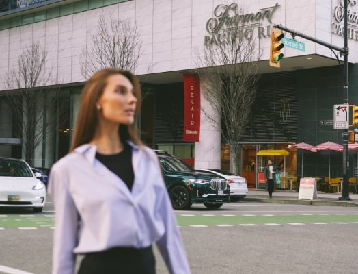 Woman outside Fairmont Pacific Rim looking for Labour Day weekend activities in Vancouver
