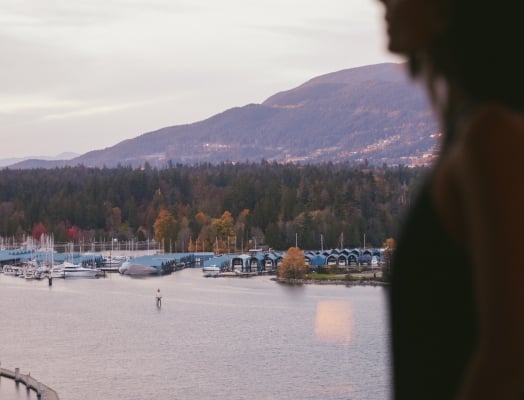 Woman overlooking autumn in Vancouver views from a luxury downtown hotel