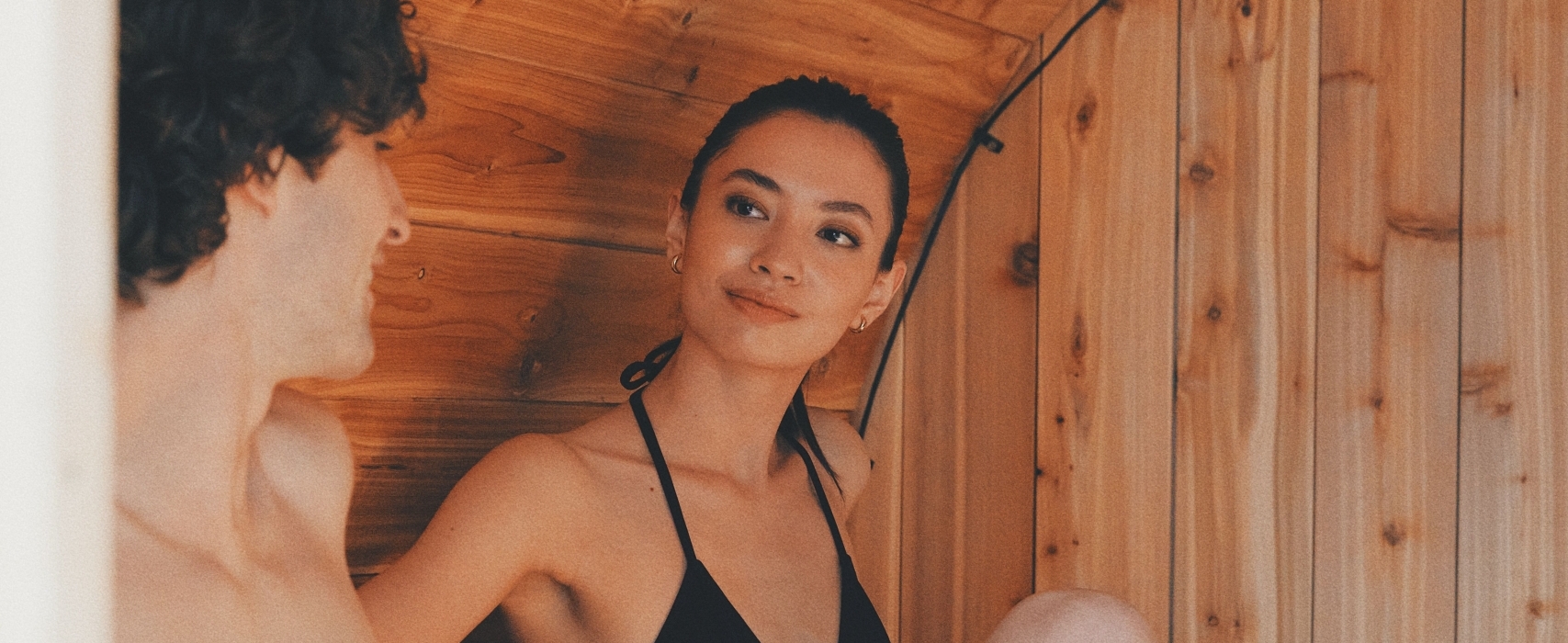 A couple relaxing at the cedar plank sauna in Vancouver at The Nordic Spa