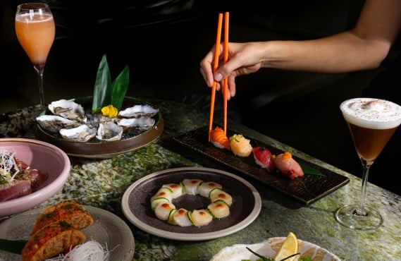 A table of Asian shareable dishes and sushi on downtown Vancouver