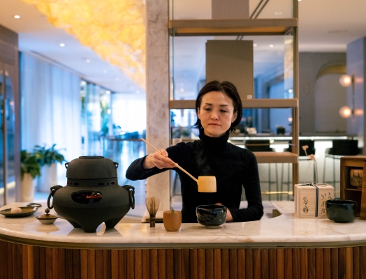 Woman making matcha tea at TASCHEN inside Fairmont pacific Rim