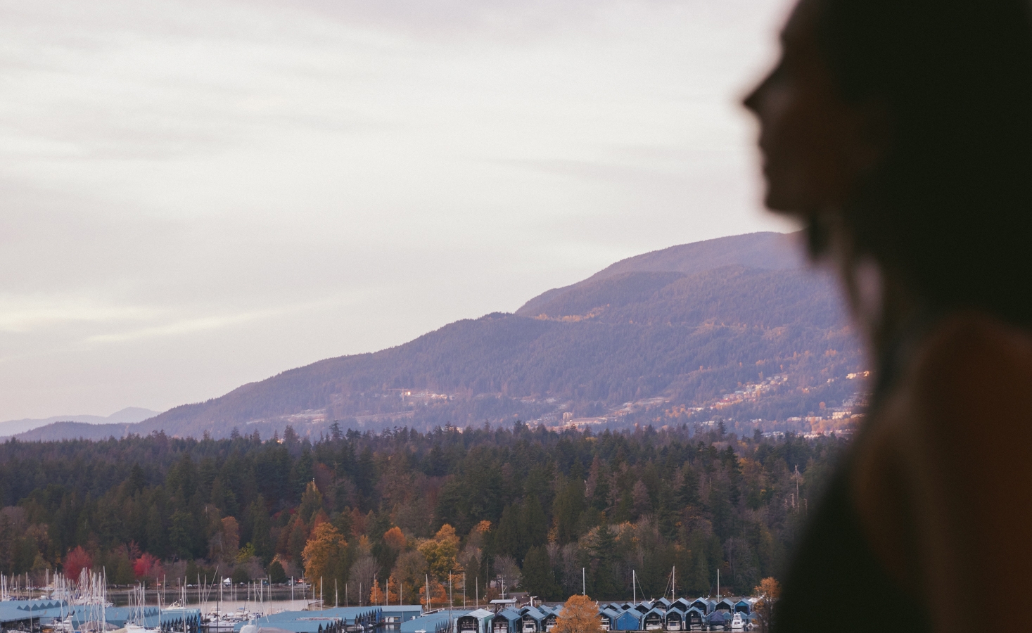 A woman looking at a hotel room with a beautiful view of Vancouver