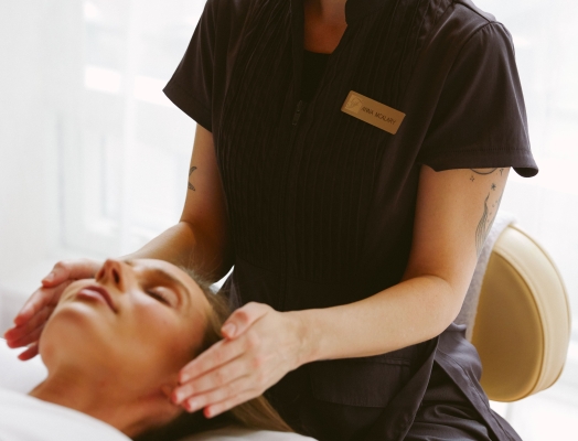 Woman getting a facial at Fairmont Spa at Fairmont Pacific Rim