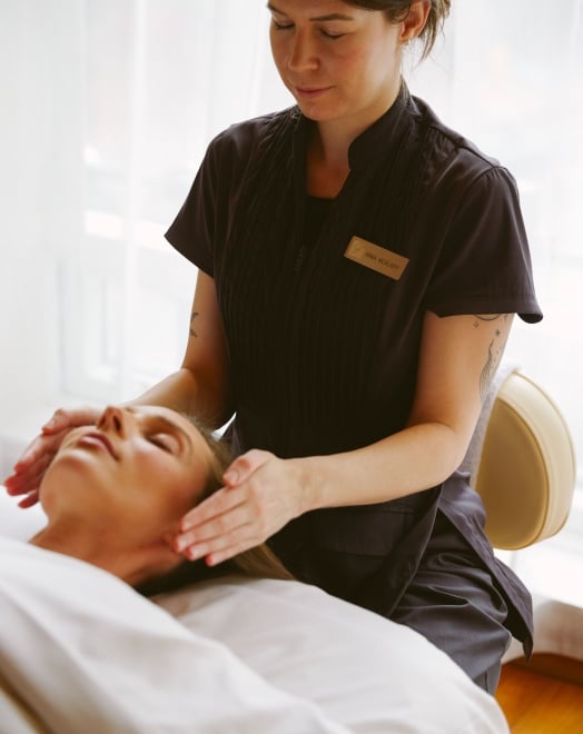 Woman getting a facial at Fairmont Spa at Fairmont Pacific Rim
