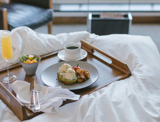 breakfast tray on top of a bed